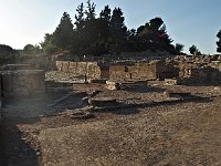 Stumps of former pillars and, behind. light from the setting sun illuminates the theater area.  gr16 092817000 s a