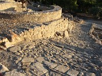 Path leading downhill beside one of the ring-shaped Kouloures, probably storage areas, belonging to the old palace.  gr16 092817333 j