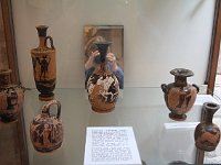 A collection of both black-figure (n the back on the left) and red-figure pottery. The photographer seems to be holding one vase by its neck, she likes them so much.  gr16 092511281 j