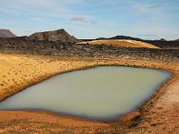 An opaque, milky-looking thermal lake and a view over the northeast lava field