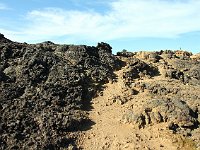 The path goes upward, One of the path-marker stakes is visible on the horizon to the right.