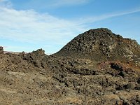 Dried lava is mostly black or dark grey (basalt?), but interspersed with rhyolite and other mineral color.