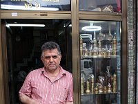 Promenades in Istanbul  This man greeted John with "Guten Tag". Turned out he had worked for years in Germany, but he was happy to be at home in Istanbul again. John purchased the coffee pot and pepper shaker the man is holding.