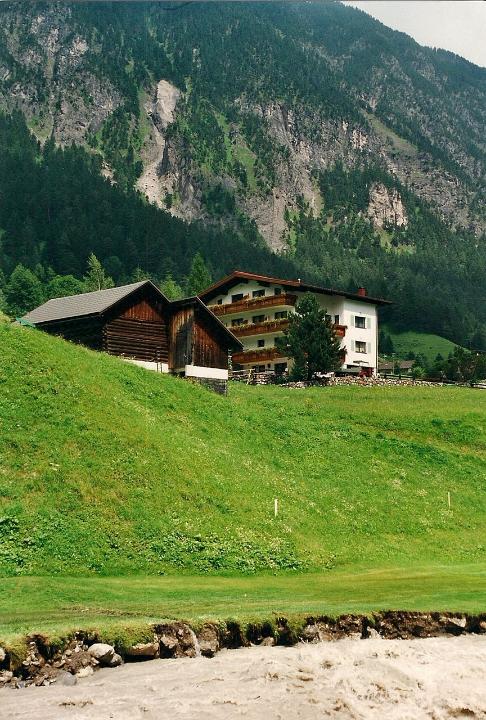 br00_kellaegg_rain_a.jpg - Melting snow and heavy rains had caused the Bach (creek) to become a silt-laden torrent, washing away parts of the silly golf course. Our home away from home, Haus Kella-Egg, is in the background.