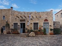 An old lady (a widow, to judte by the black outfit) has just bought bread for the day.  gr18 093010061 k