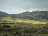 Passing clouds gave fascinating lighted spots on the bright green of the land.