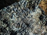 Blue colors in a light-weight, extremely fragile piece of vesicular lava, probably basalt