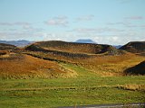 A false crater, or pseudocrater, or rootless vent. There are many of these on the south shore of Mývatn. They result not from a volcanic vent beneath them, but from an explosion when a laterally-flowing lava flow encounters a moist area and explodes.