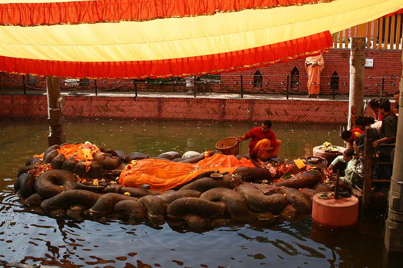 ne08_100409490_j.jpg - At Budhanilkantha, a seventh or eighth-century statue of Narayan (Vishnu) sleeps on the coils of the snake Ananta, floating on the cosmic waters.