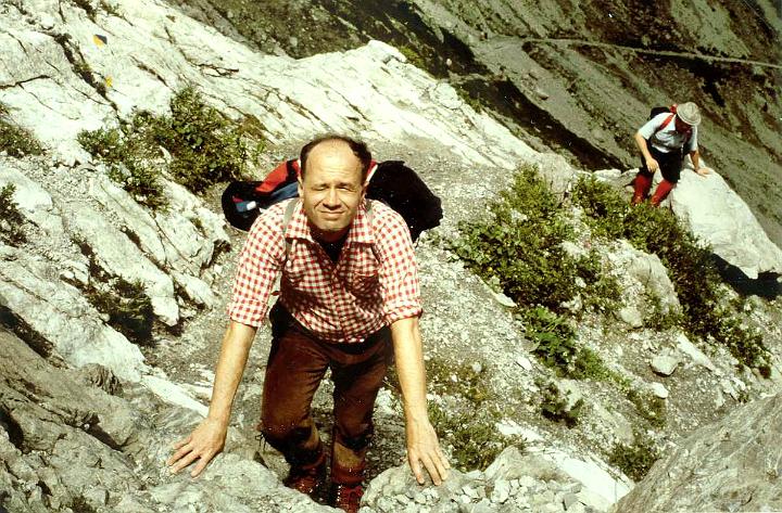 br83_btritt_a.jpg - John preparing for a high step up. The beginning of the climbing with the more level path showing in the back.