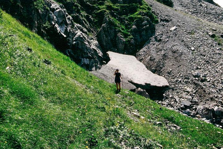br95_fluralp_02.jpg - Siv or John against the bridge of hard snow that allows you to make your way to the Jagdhütte (hunting lodge). This picture was taken in 1995. The last time we tried this walk was after the terrible landslides in '99. The snow was gone and there was just no way we could make it across the ravine, down one steep side and up another. We had to turn back.