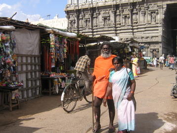 Blind man led by woman
